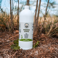 Moringa Utopia concentrate bottle on a natural outdoor background