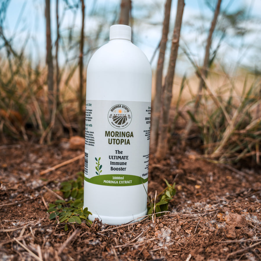 Moringa Utopia leaf juice concentrate bottle outdoors on the farm